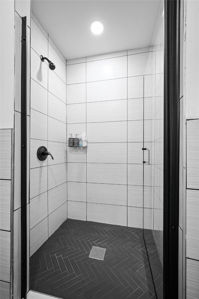 bathroom featuring a shower with shower door