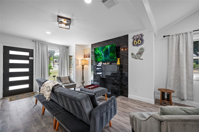 living room with wood-type flooring and lofted ceiling