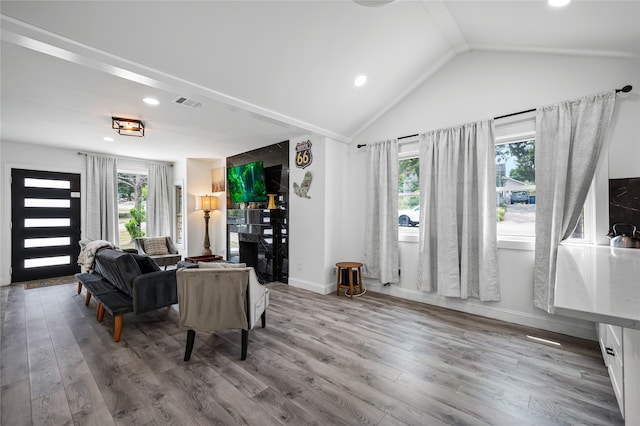 living room with vaulted ceiling and hardwood / wood-style floors