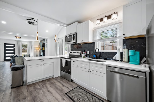 kitchen with white cabinets, appliances with stainless steel finishes, and sink