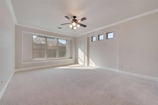 spare room with crown molding, ceiling fan, and a healthy amount of sunlight