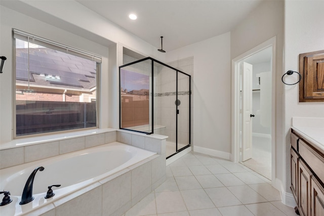 bathroom featuring tile patterned flooring, vanity, and separate shower and tub