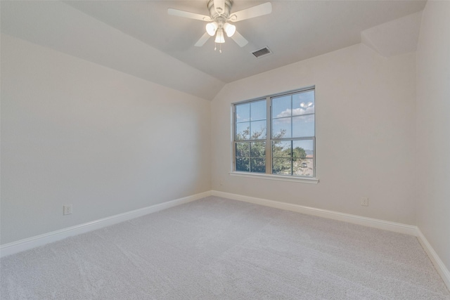 carpeted empty room with ceiling fan and lofted ceiling