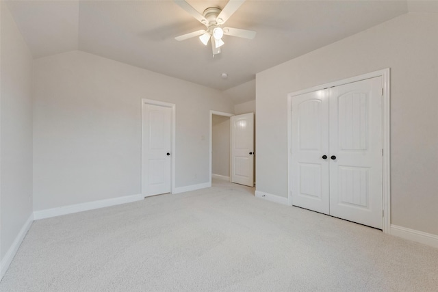 unfurnished bedroom with ceiling fan, light carpet, and vaulted ceiling