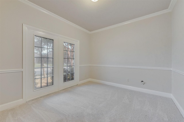 carpeted spare room featuring crown molding and french doors