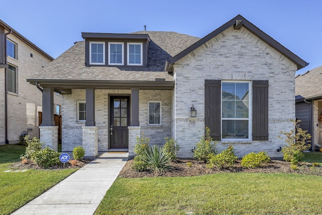 view of front of house featuring a front lawn and a porch