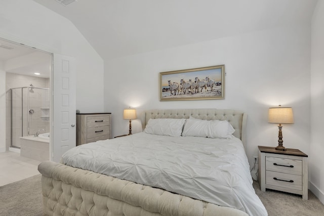 carpeted bedroom with lofted ceiling and ensuite bathroom