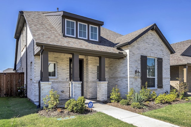 view of front of house with a front lawn and covered porch