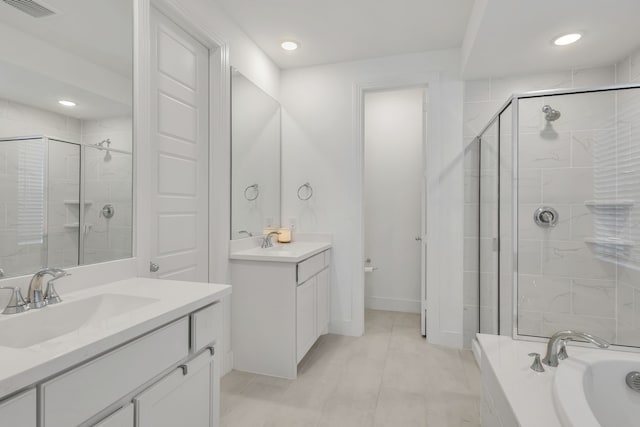 bathroom featuring independent shower and bath, vanity, and tile patterned floors