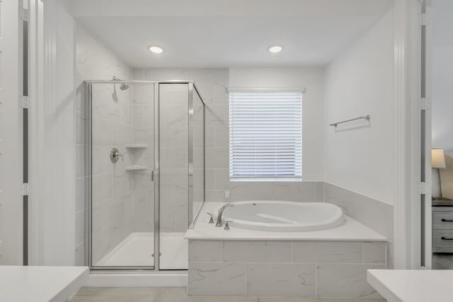 bathroom with shower with separate bathtub