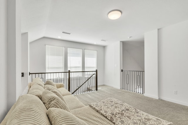 interior space featuring lofted ceiling and carpet flooring