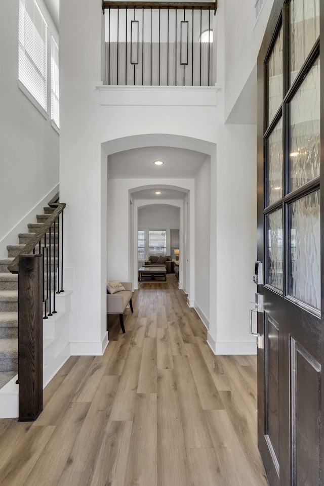 entryway featuring light hardwood / wood-style flooring and a high ceiling