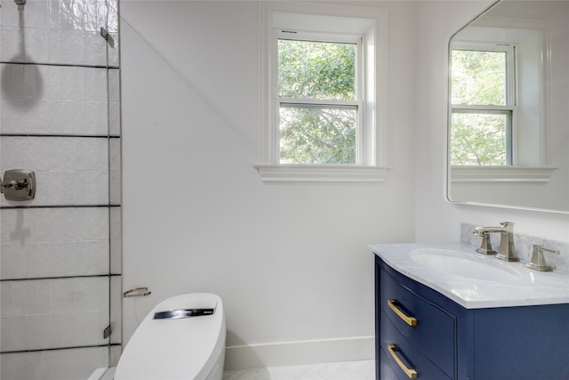 bathroom featuring vanity, toilet, and a wealth of natural light