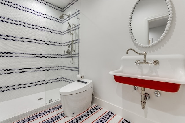 bathroom with tiled shower and toilet