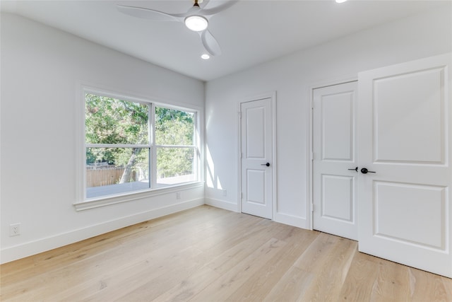 unfurnished bedroom featuring ceiling fan and light hardwood / wood-style flooring