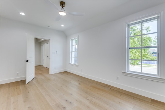 spare room with plenty of natural light, light wood-type flooring, and ceiling fan