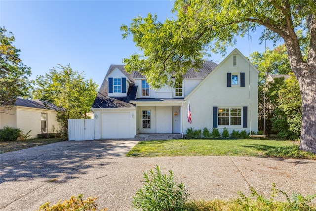 view of front of property with a garage and a front lawn