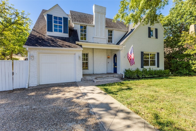 view of front of home featuring a garage and a front lawn