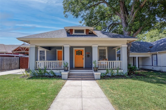 bungalow featuring a front lawn and a porch