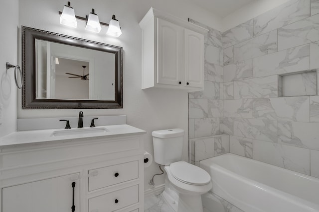 full bathroom with ceiling fan, tiled shower / bath, vanity, and toilet