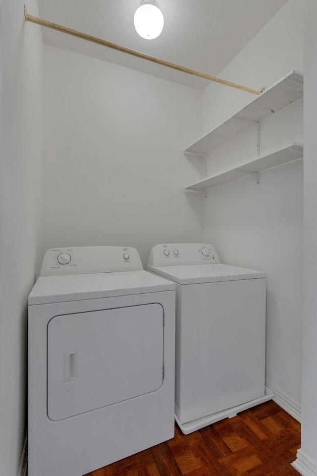 clothes washing area featuring washer and clothes dryer and dark hardwood / wood-style floors