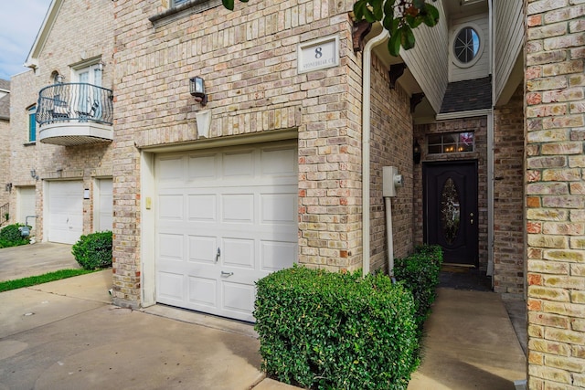 property entrance featuring a balcony and a garage