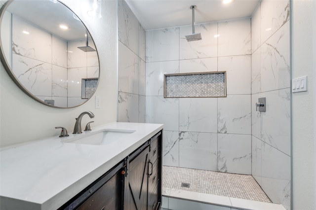 bathroom with vanity and tiled shower