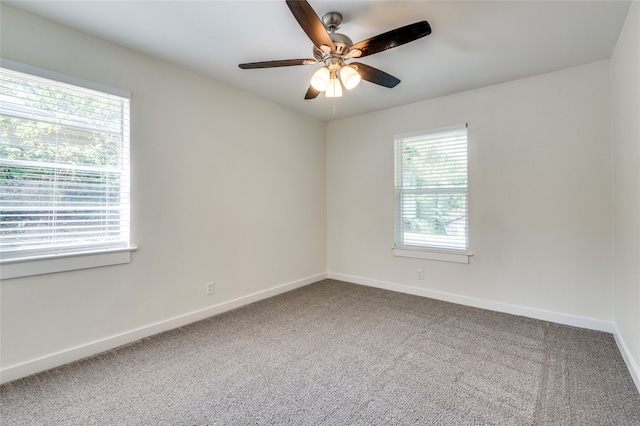 carpeted spare room featuring ceiling fan