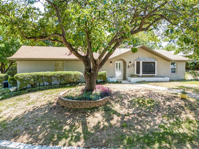 single story home featuring central AC unit