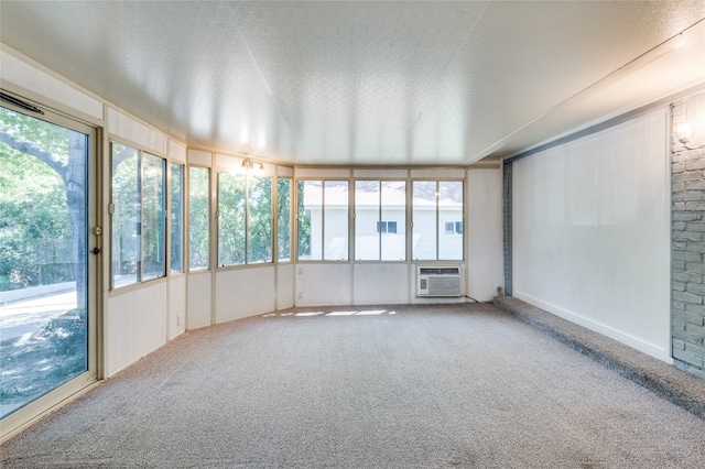 unfurnished sunroom featuring a wealth of natural light and a wall mounted AC