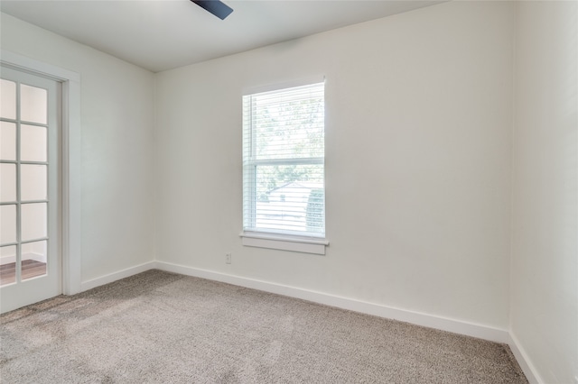 spare room featuring carpet and ceiling fan