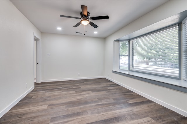 empty room featuring ceiling fan and dark hardwood / wood-style floors