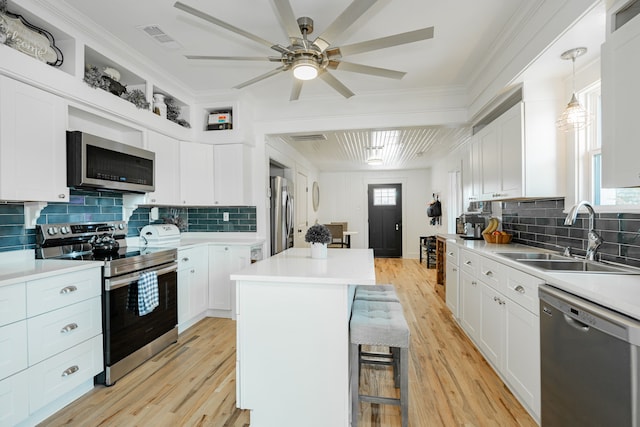 kitchen with ceiling fan, sink, light hardwood / wood-style flooring, white cabinetry, and appliances with stainless steel finishes