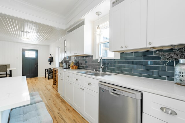 kitchen featuring light hardwood / wood-style floors, sink, white cabinets, hanging light fixtures, and stainless steel dishwasher