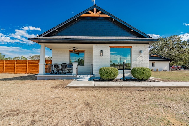 exterior space featuring ceiling fan, a front yard, and a patio