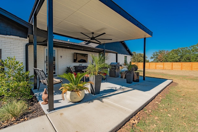 view of patio with area for grilling and ceiling fan