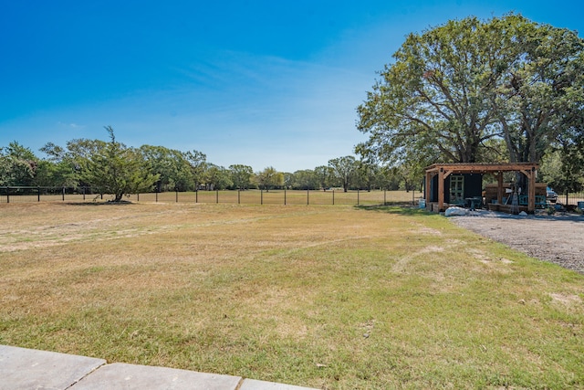 view of yard with a pergola and a rural view