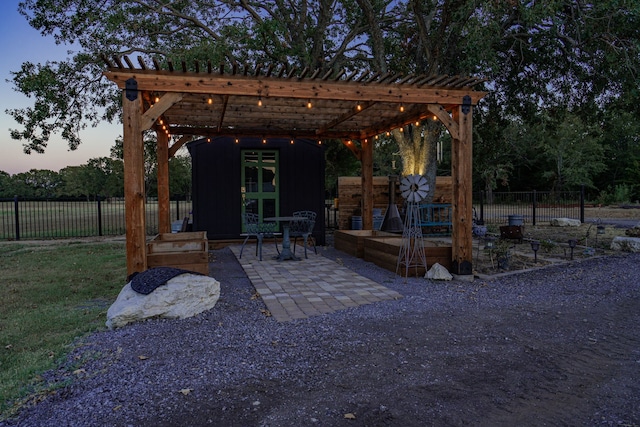 back house at dusk featuring a yard