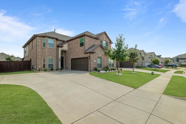 view of front of house with a front yard and a garage