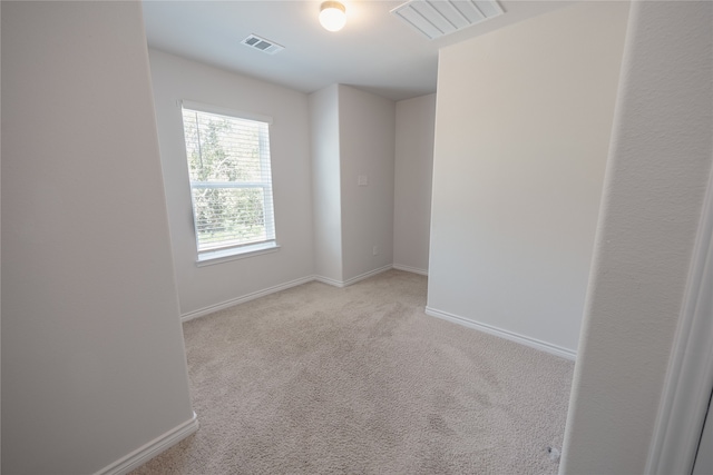 unfurnished room with light carpet