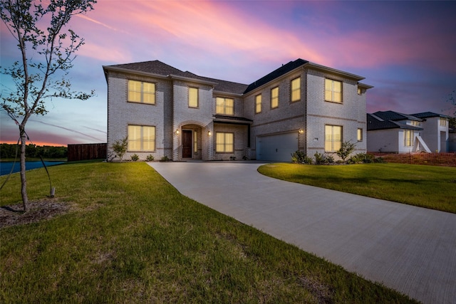 view of front facade featuring a lawn and a garage