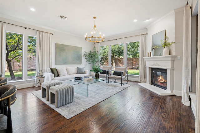 living room with a notable chandelier, plenty of natural light, dark hardwood / wood-style floors, and crown molding