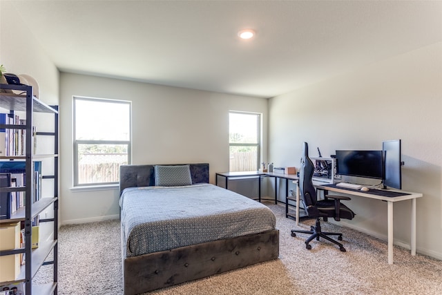 carpeted bedroom featuring multiple windows