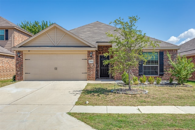 view of front of property with a front yard and a garage