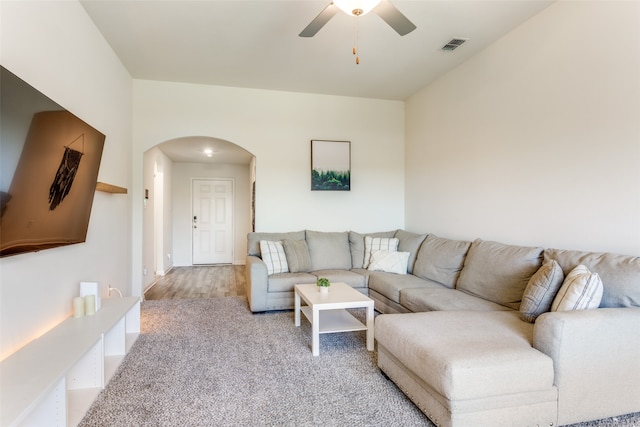 living room featuring light hardwood / wood-style flooring and ceiling fan