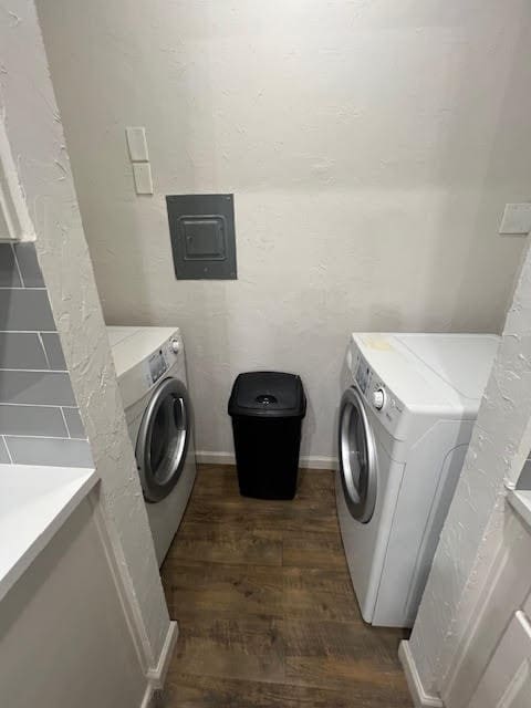 laundry area featuring electric panel, dark hardwood / wood-style floors, and washer and dryer