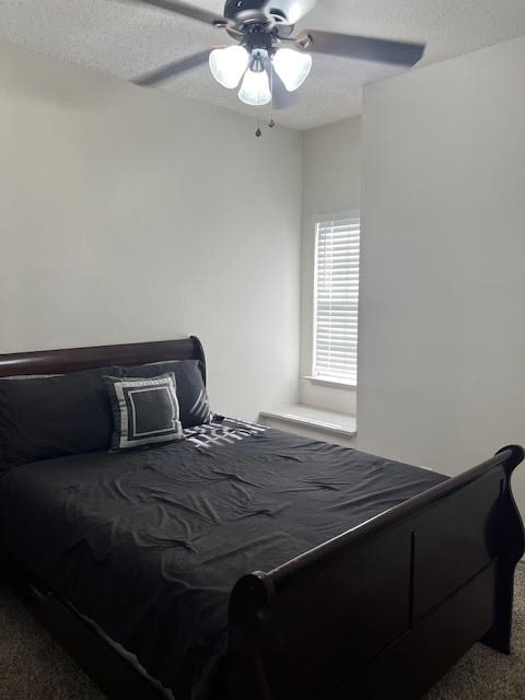 carpeted bedroom featuring ceiling fan