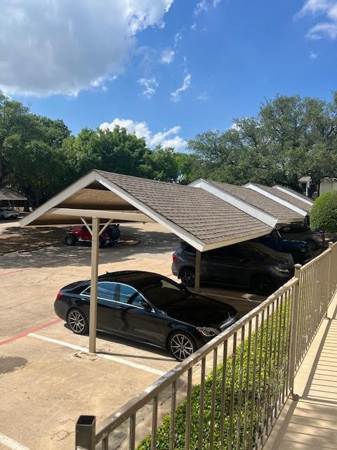 view of vehicle parking with a carport