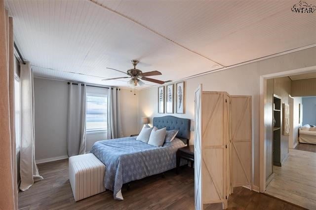 bedroom featuring ceiling fan and dark wood-type flooring