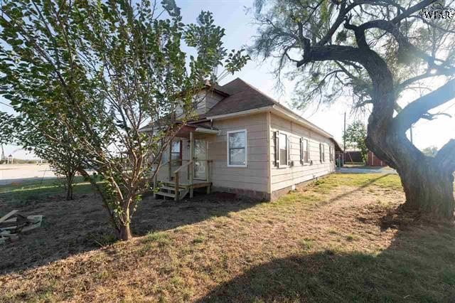 view of side of property with a yard